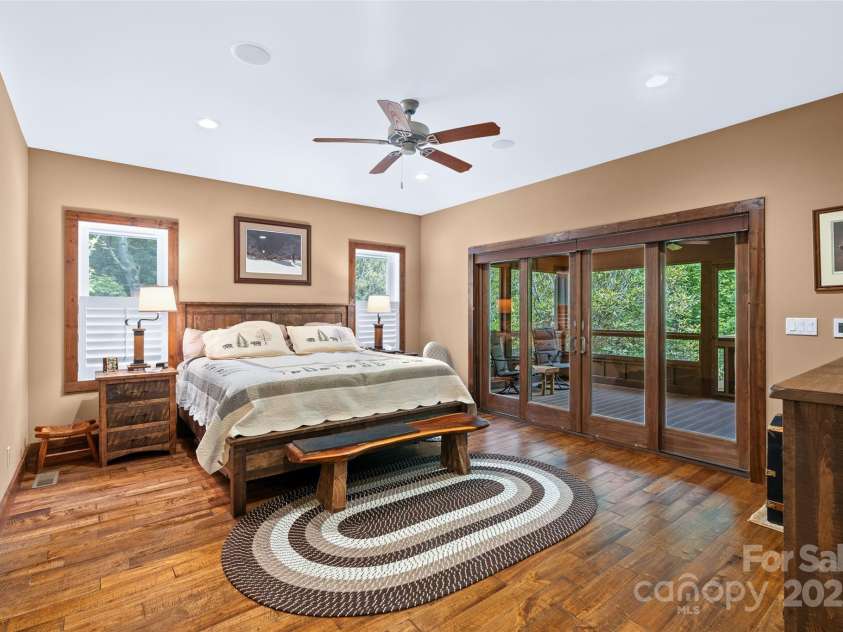 55 Lake Drive, Fairview, NC 28730.  MLS# CAR4272386, YatesRealty ID 33918. Primary bedroom with its own screened porch