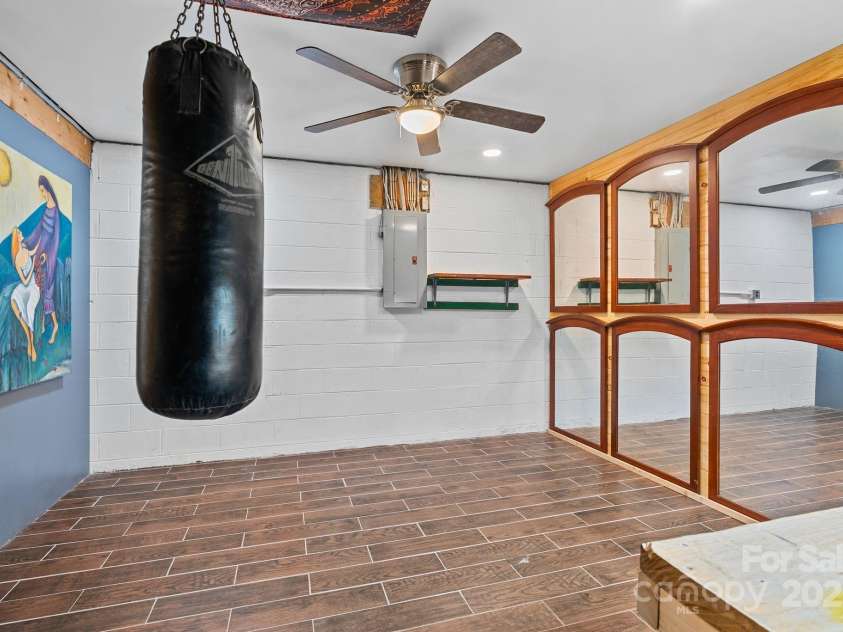 19 Mountain Brook Drive, Candler, NC 28715.  MLS# CAR4286834, YatesRealty ID 33932. Lowe level bonus room used as workout space and worshshop
