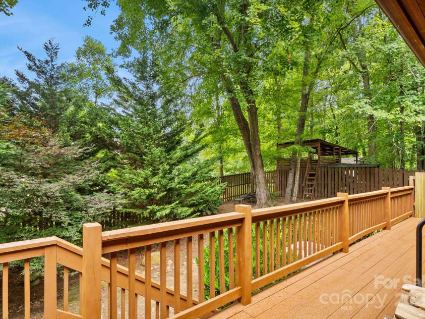 19 Mountain Brook Drive, Candler, NC 28715.  MLS# CAR4286834, YatesRealty ID 33932. Wrap around deck has access to fenced in side yard