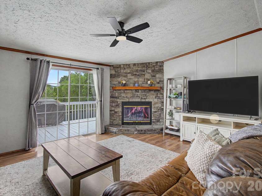 22 Sweet Briar Path Way, Hendersonville, NC 28792.  MLS# CAR4396421, YatesRealty ID 33933. Living room with deck access