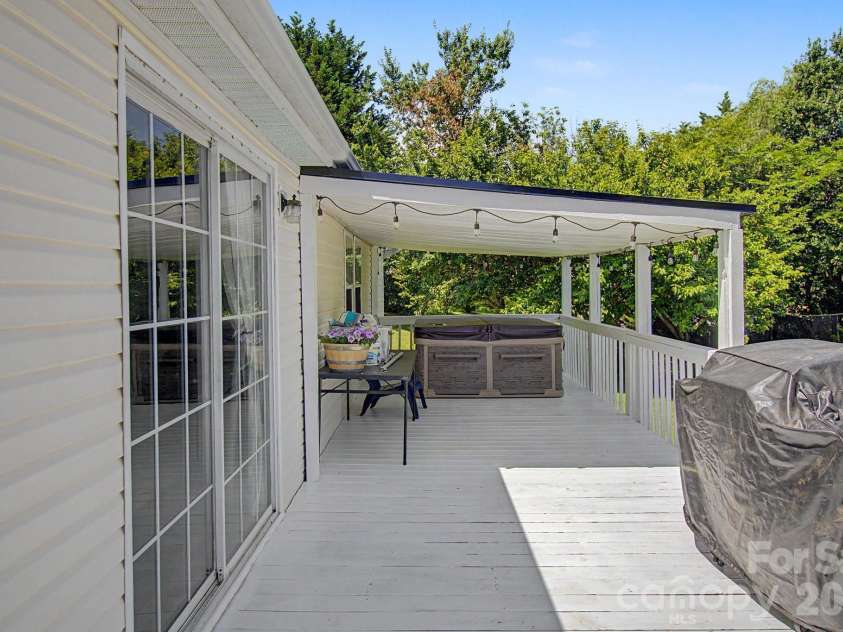 22 Sweet Briar Path Way, Hendersonville, NC 28792.  MLS# CAR4396421, YatesRealty ID 33933. Partially covered back deck with hot tub