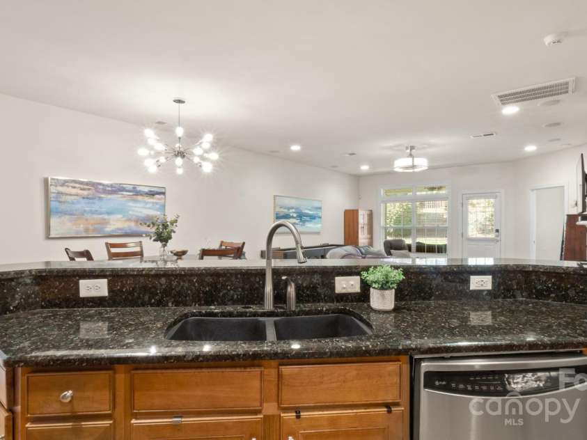 8534 Loxton Circle, Charlotte, NC 28214.  MLS# CAR4232602, YatesRealty ID 3394. Huge kitchen island with sparkling granite overlooks the broad open concept living & dining spaces