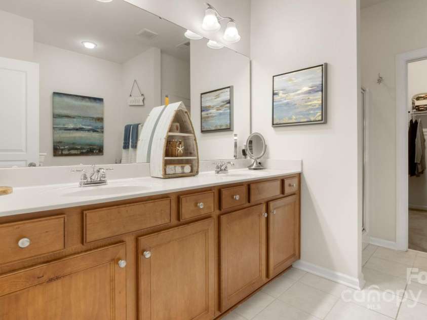 8534 Loxton Circle, Charlotte, NC 28214.  MLS# CAR4232602, YatesRealty ID 3394. Primary ensuite has double sinks and excellent storage, leads to large walk-in primary closet