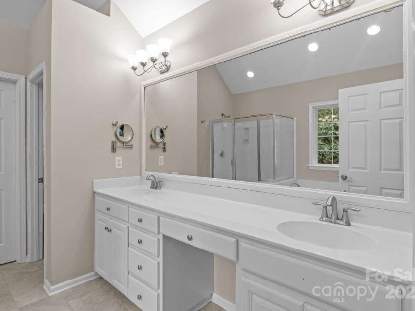 16923 Laureate Road, Huntersville, NC 28078.  MLS# CAR4286306, YatesRealty ID 33940. Vaulted ceiling and tiled flooring in primary bathroom
