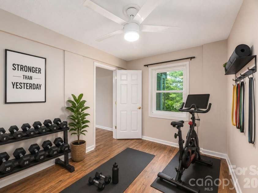 23 Moriah Lane, Asheville, NC 28803.  MLS# CAR4396349, YatesRealty ID 33943. Basement bonus room virtually staged as an exercise room.