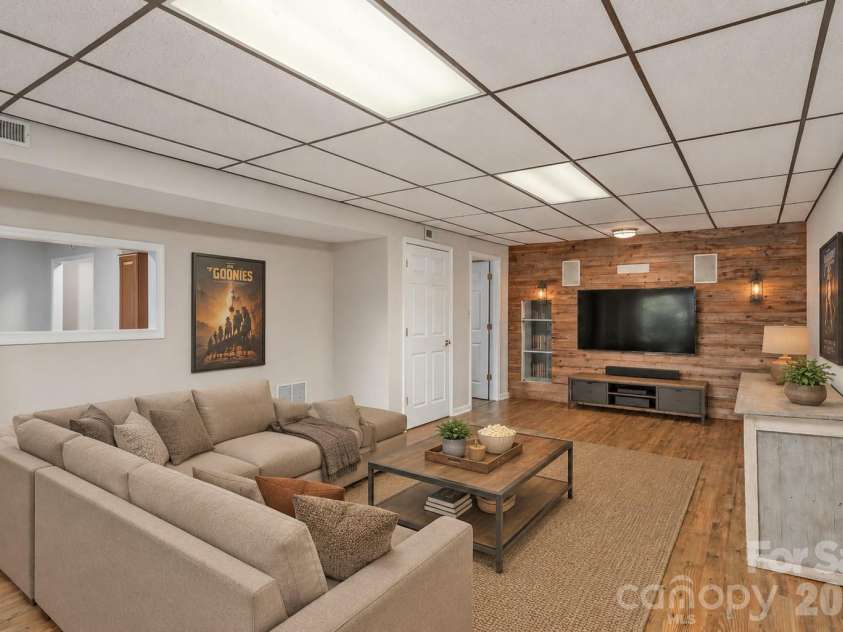 23 Moriah Lane, Asheville, NC 28803.  MLS# CAR4396349, YatesRealty ID 33943. Finished basement virtually staged as a media room.
