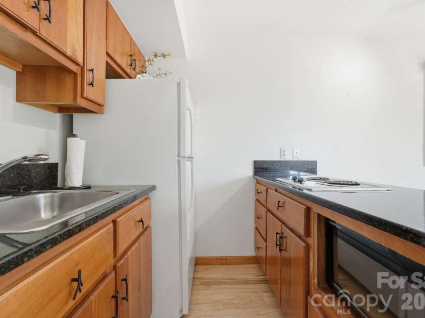 11150 Highway 19W Highway, Bryson City, NC 28713.  MLS# CAR4394806, YatesRealty ID 33948. Kitchenette with solid wood cabinets and granite countertops
