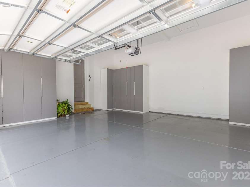 6059 Ancestry Trail, Indian Land, SC 29707.  MLS# CAR4289707, YatesRealty ID 33970. Epoxy-coated 2-car garage with storage