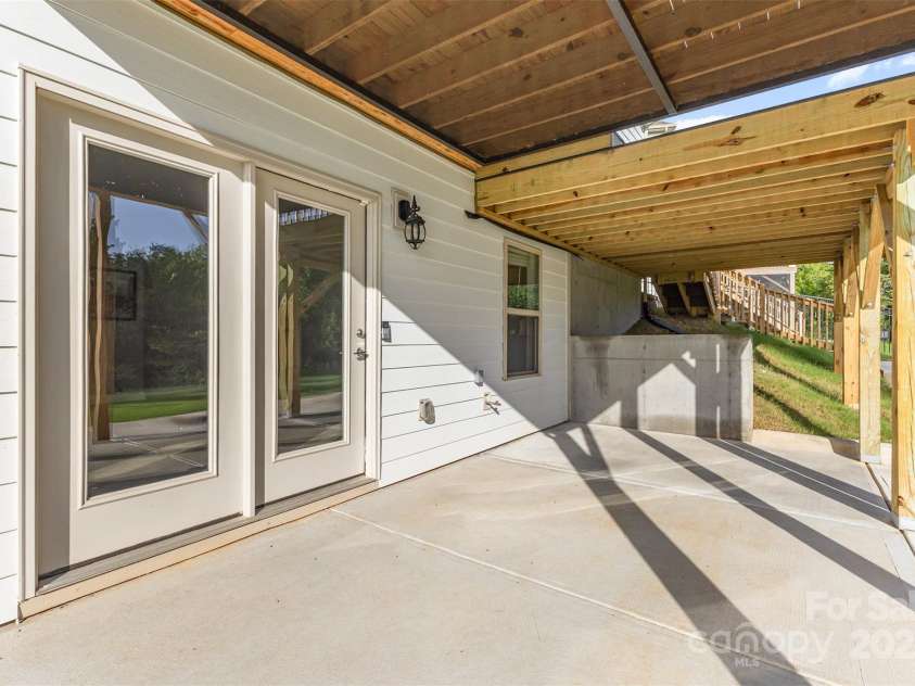 6059 Ancestry Trail, Indian Land, SC 29707.  MLS# CAR4289707, YatesRealty ID 33970. Patio area beneath deck