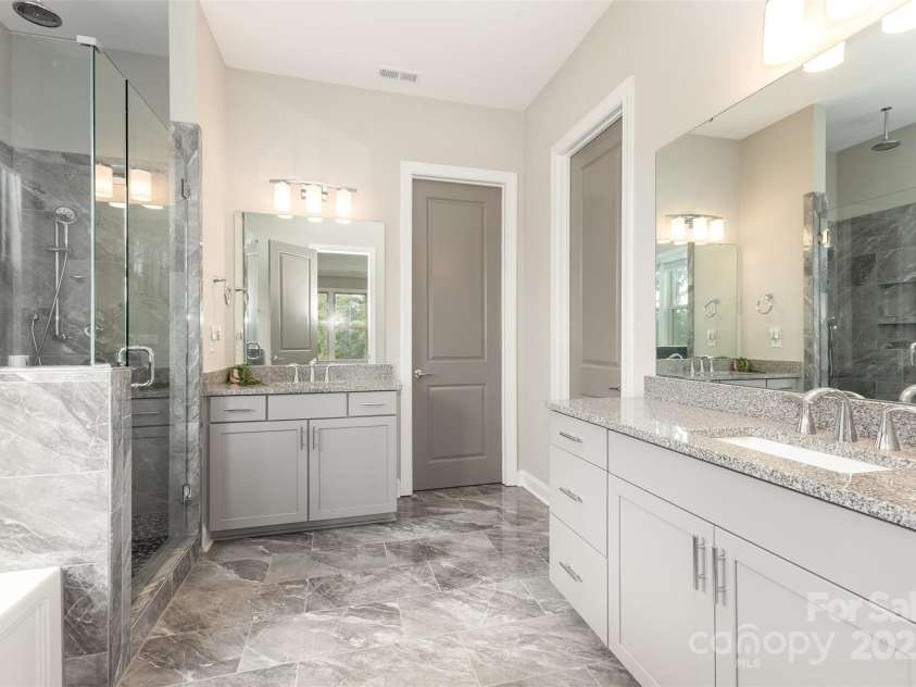 6059 Ancestry Trail, Indian Land, SC 29707.  MLS# CAR4289707, YatesRealty ID 33970. Spa bath with frameless shower & garden tub