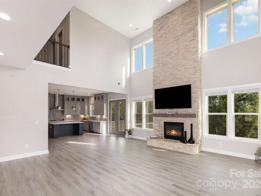 6059 Ancestry Trail, Indian Land, SC 29707.  MLS# CAR4289707, YatesRealty ID 33970. Two-story stone fireplace with cedar mantel