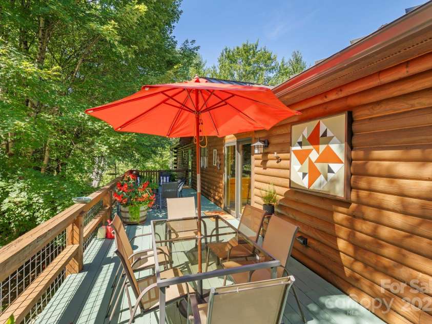85 Rock Rest Road, Hendersonville, NC 28739.  MLS# CAR4282137, YatesRealty ID 33979. Comfy deck adjacent to the kitchen makes for wonderful entertaining space!