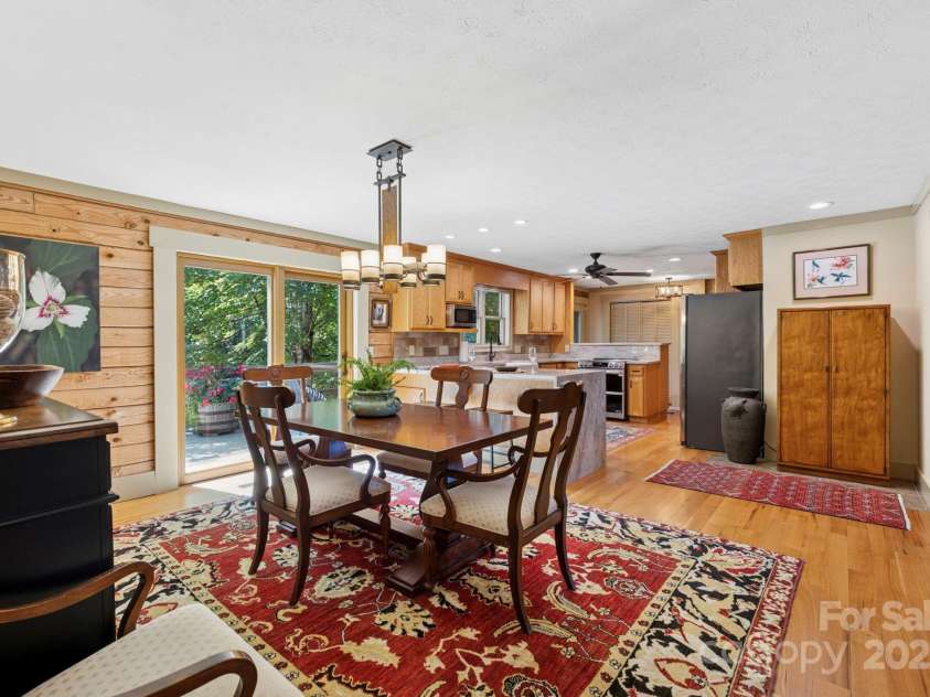 85 Rock Rest Road, Hendersonville, NC 28739.  MLS# CAR4282137, YatesRealty ID 33979. Dining area open to Kitchen and deck sliders