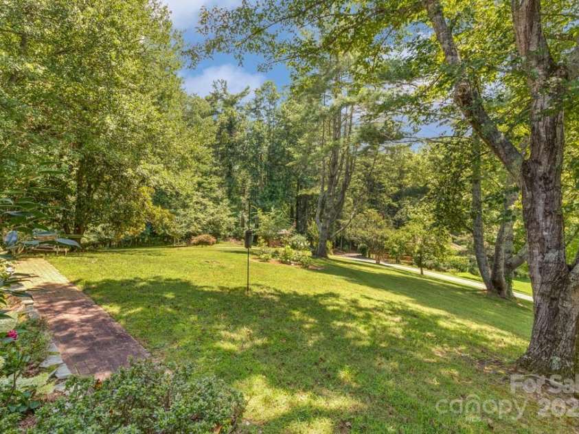 85 Rock Rest Road, Hendersonville, NC 28739.  MLS# CAR4282137, YatesRealty ID 33979. Gardens with mature shade trees