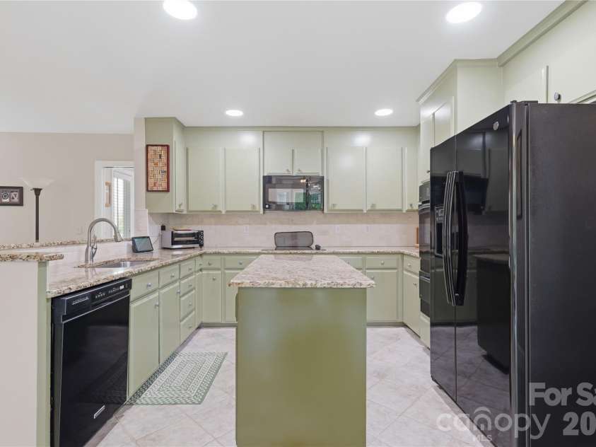 2402 Beaucatcher Lane, Charlotte, NC 28270.  MLS# CAR4394384, YatesRealty ID 34019. Kitchen has soft green painted cabinets & granite counters