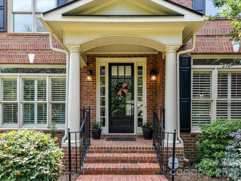 515 Three Greens Drive, Huntersville, NC 28078.  MLS# CAR4397315, YatesRealty ID 34047. A charming covered front porch with stately columns and elegant brick steps creates a warm, inviting entrance and a beautiful first impression.