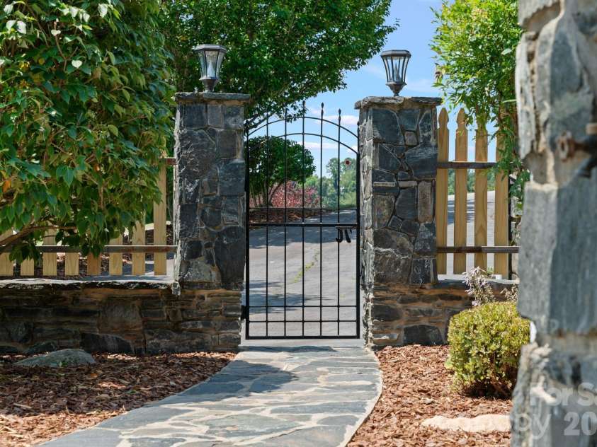 195 Oak Lane, Mars Hill, NC 28754.  MLS# CAR4394018, YatesRealty ID 34054. Custom rock work on house, fence, columns, retaining wall, and mailbox