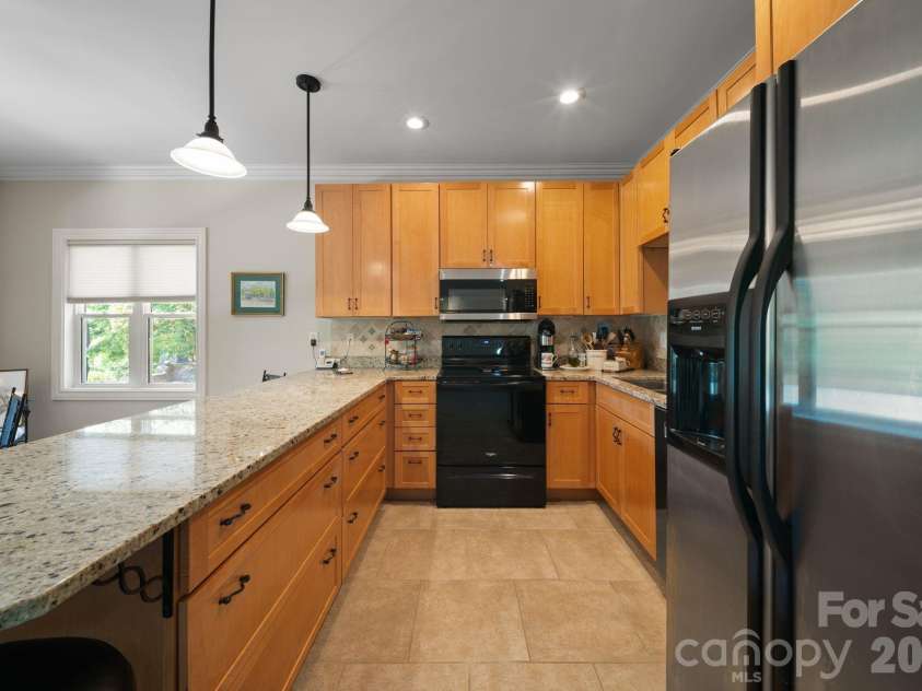 195 Oak Lane, Mars Hill, NC 28754.  MLS# CAR4394018, YatesRealty ID 34054. Kitchen equipped with granite, oversized oak cabinets and tile flooring.
