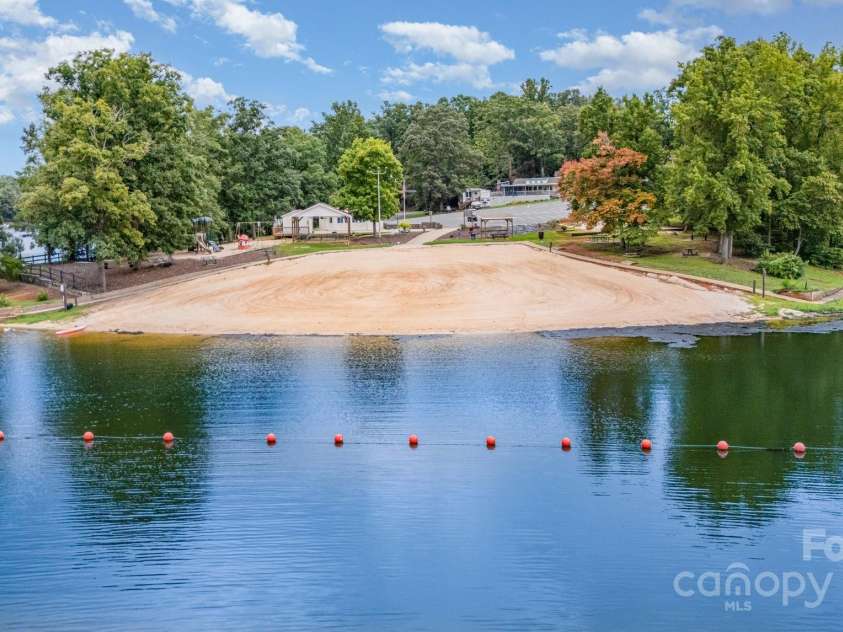 115 Trails End Lane, New London, NC 28127.  MLS# CAR4281214, YatesRealty ID 34059. Sandy Beach and lake swim area