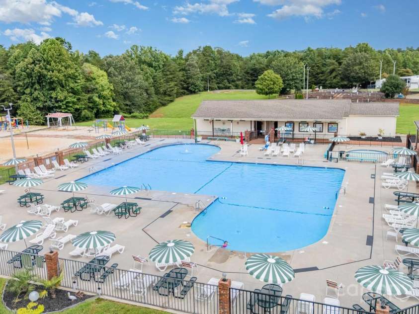 115 Trails End Lane, New London, NC 28127.  MLS# CAR4281214, YatesRealty ID 34059. Swimming pool and bath houses