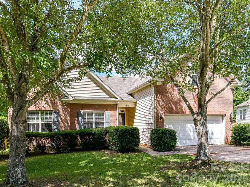 18418 Torrence Chapel Estates Circle, Cornelius, NC 28031.  MLS# CAR4392160, YatesRealty ID 34069. Nestled among mature trees on a spacious corner lot, this beautifully maintained brick home offers timeless curb appeal, a side-entry garage, and a welcoming setting in a sought-after neighborhood.