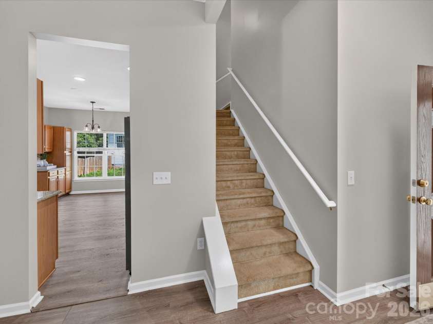 18418 Torrence Chapel Estates Circle, Cornelius, NC 28031.  MLS# CAR4392160, YatesRealty ID 34069. The centrally located staircase provides easy access to the upper level while maintaining the home's open and functional flow between living spaces.