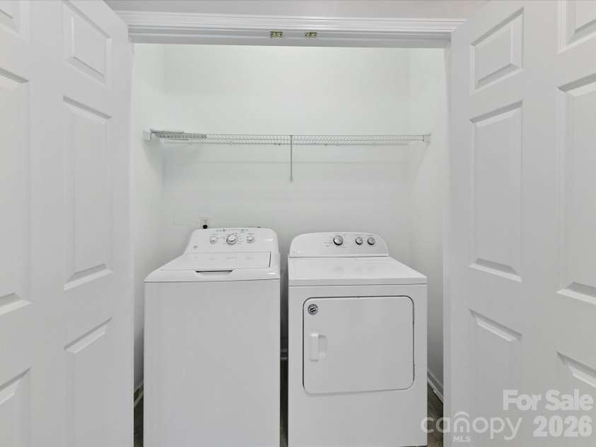 18418 Torrence Chapel Estates Circle, Cornelius, NC 28031.  MLS# CAR4392160, YatesRealty ID 34069. The conveniently located laundry area features built-in shelving for additional storage and easy access to simplify everyday household tasks.