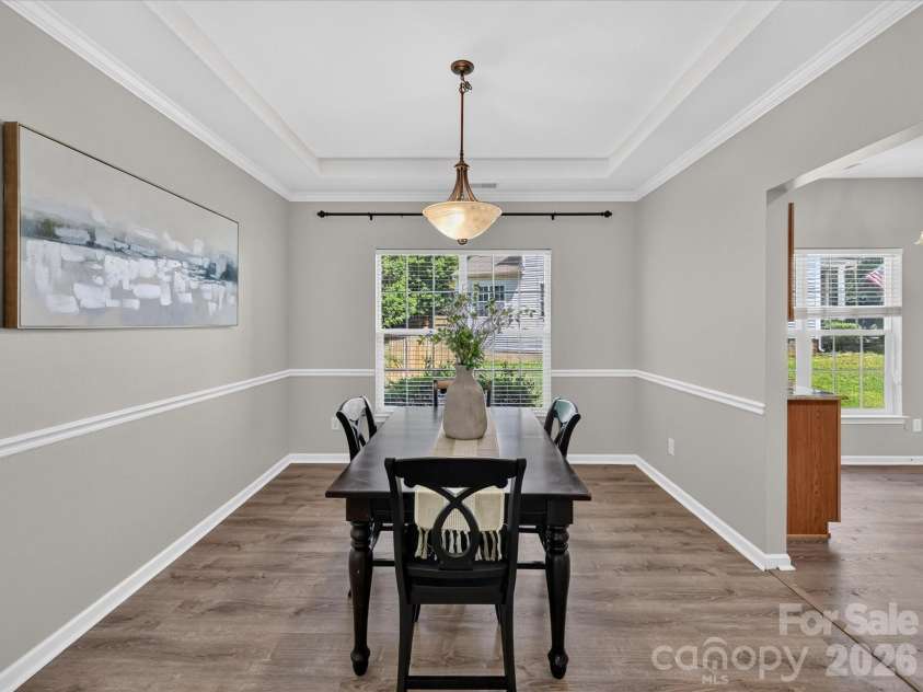 18418 Torrence Chapel Estates Circle, Cornelius, NC 28031.  MLS# CAR4392160, YatesRealty ID 34069. The elegant dining room features crown molding, chair rail detailing, abundant natural light, and ample space for hosting memorable gatherings and holiday celebrations.