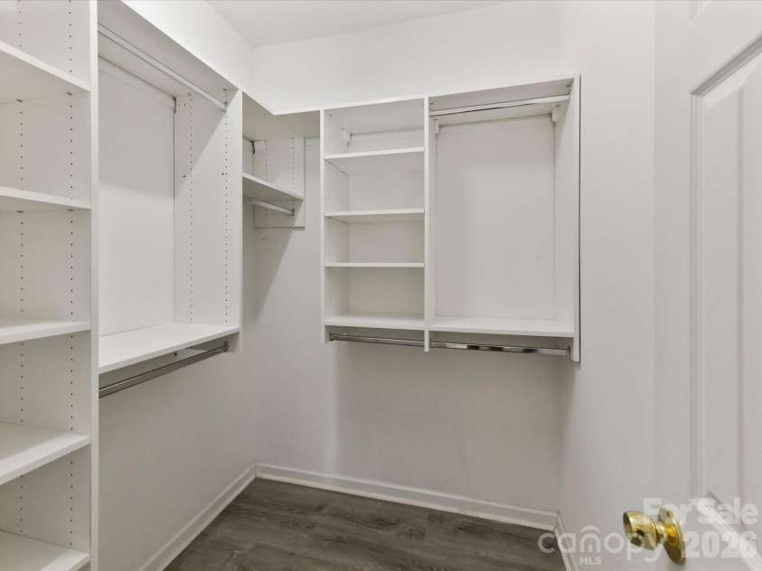 18418 Torrence Chapel Estates Circle, Cornelius, NC 28031.  MLS# CAR4392160, YatesRealty ID 34069. The large walk-in closet features a custom organization system with built-in shelving, hanging space, and abundant storage to keep everything neatly arranged.