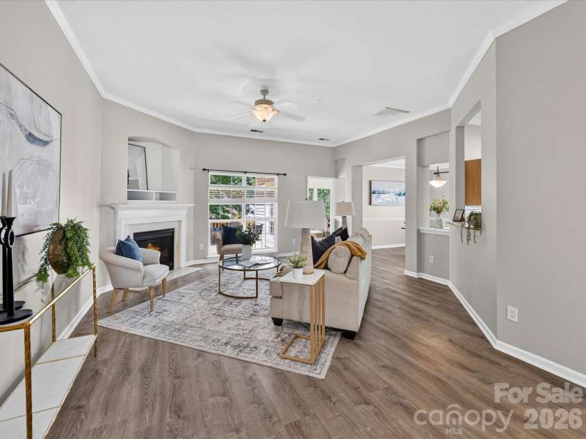 18418 Torrence Chapel Estates Circle, Cornelius, NC 28031.  MLS# CAR4392160, YatesRealty ID 34069. The spacious family room features soaring ceilings, abundant natural light, updated flooring, and a cozy fireplace, creating the perfect setting for both relaxing and entertaining.