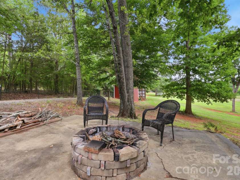 8301 Waxhaw Creek Road, Waxhaw, NC 28173.  MLS# CAR4393275, YatesRealty ID 34071. Backyard patio with fire pit