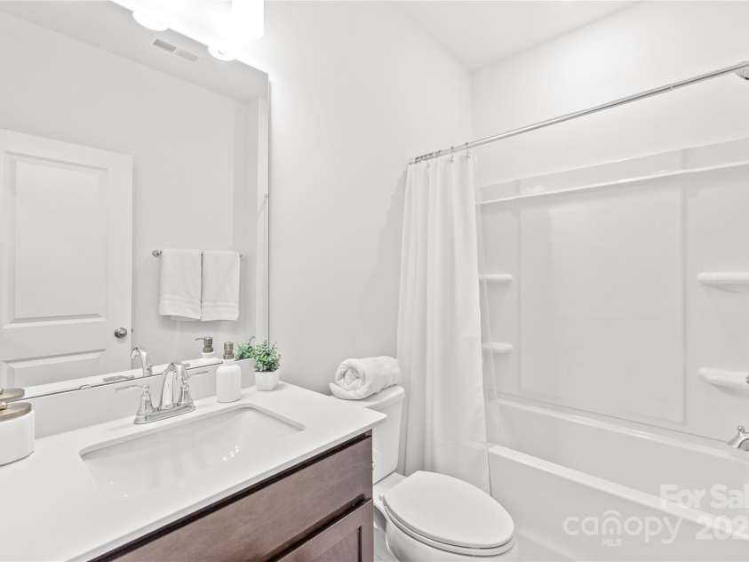 1507 Cedar Tree Drive, Belmont, NC 28012.  MLS# CAR4289479, YatesRealty ID 34147. Guest bathroom with comfort height comode and vanity