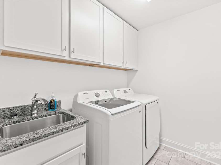 1507 Cedar Tree Drive, Belmont, NC 28012.  MLS# CAR4289479, YatesRealty ID 34147. Large laundry room with granite, sink, and cabinets