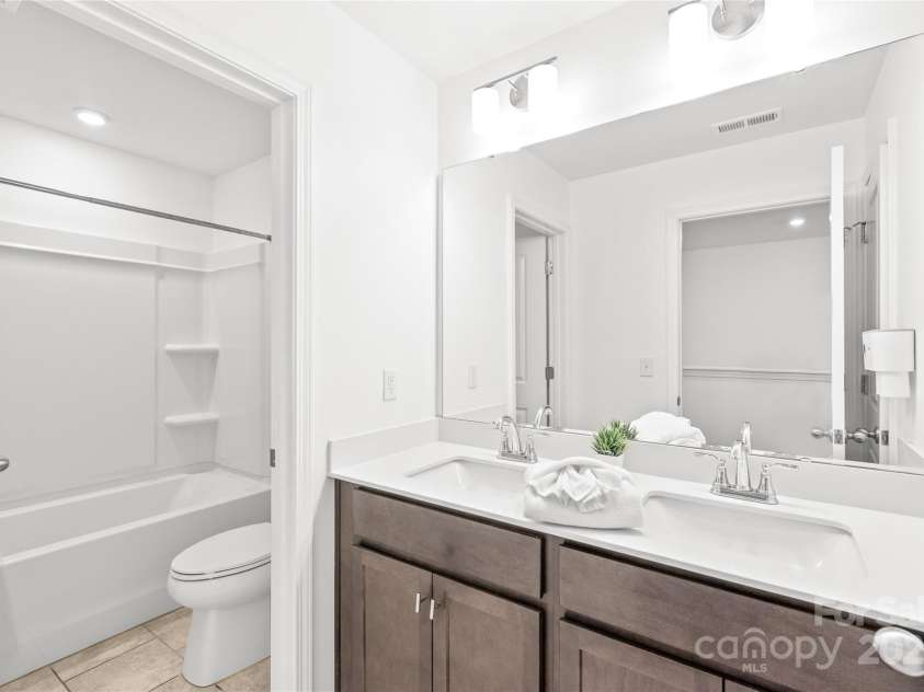 1507 Cedar Tree Drive, Belmont, NC 28012.  MLS# CAR4289479, YatesRealty ID 34147. Secondary bath has dual vanity and separate shower/ commode room