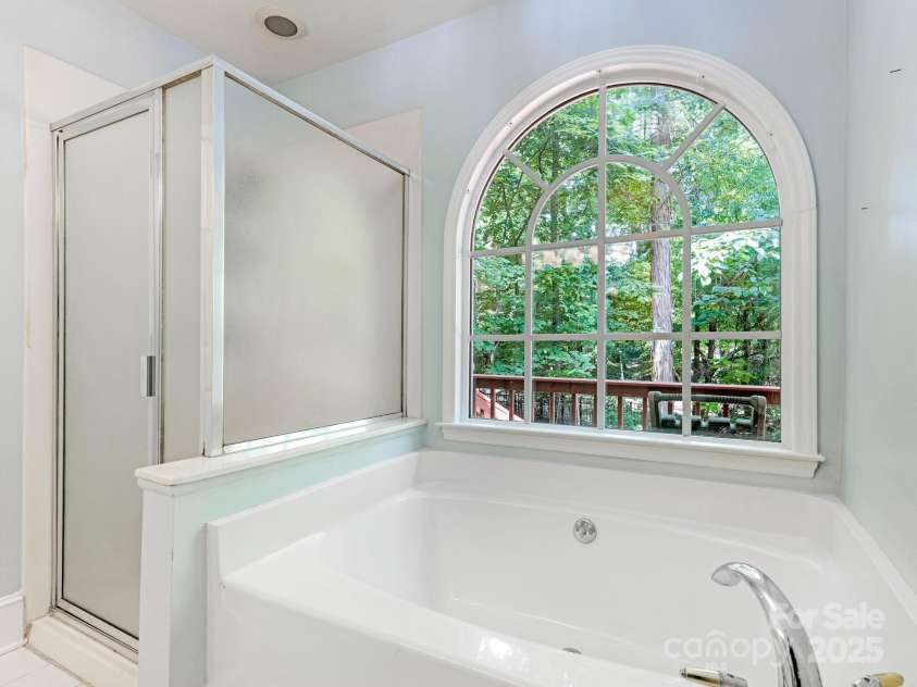 6907 Pleasant Drive, Charlotte, NC 28211.  MLS# CAR4280958, YatesRealty ID 34148. Featuring a shower and tub with a view...
