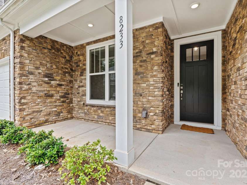 8233 Merryvale Lane, Charlotte, NC 28214.  MLS# CAR4293433, YatesRealty ID 34155. Enjoy the welcoming front porch—perfect for morning coffee, casual chats, and connecting with neighbors in true community spirit.