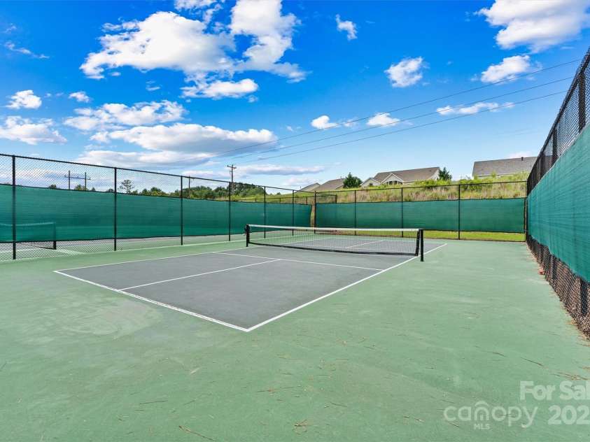 8233 Merryvale Lane, Charlotte, NC 28214.  MLS# CAR4293433, YatesRealty ID 34155. Game on! The community features well-maintained tennis and pickleball courts—perfect for friendly matches, staying active, and enjoying the outdoors with neighbors