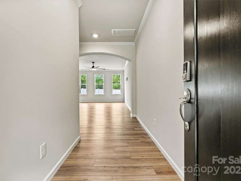 8233 Merryvale Lane, Charlotte, NC 28214.  MLS# CAR4293433, YatesRealty ID 34155. Step through the inviting entryway and discover a dedicated office to your left, while the open-concept great room unfolds straight ahead—perfect for both productivity and relaxation.