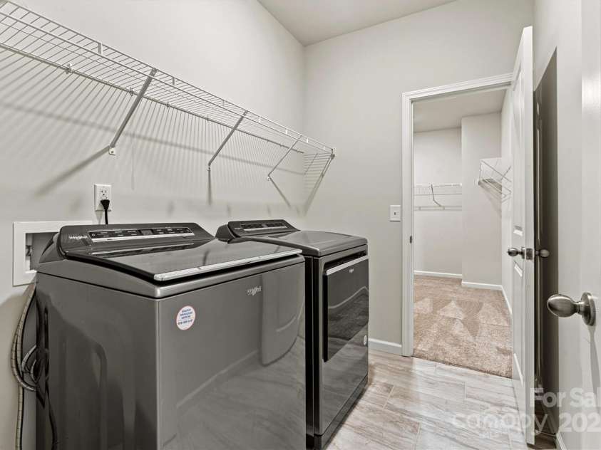 8233 Merryvale Lane, Charlotte, NC 28214.  MLS# CAR4293433, YatesRealty ID 34155. The spacious upstairs laundry room offers everyday convenience with included washer and dryer—making chores a breeze right where you need them most