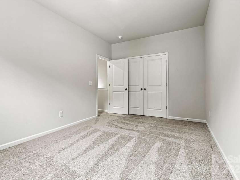 8233 Merryvale Lane, Charlotte, NC 28214.  MLS# CAR4293433, YatesRealty ID 34155. The two secondary bedrooms offer generous space, abundant natural light, and large closets—perfect for family, guests, or creating a personalized retreat.