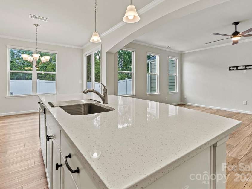 8233 Merryvale Lane, Charlotte, NC 28214.  MLS# CAR4293433, YatesRealty ID 34155. This expansive upgraded, quartz island is the heart of the kitchen—ideal for prepping meals, hosting friends, or simply gathering with family for everyday moments.