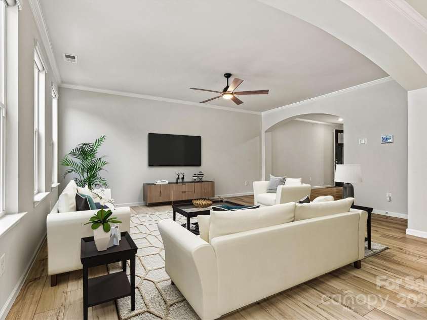 8233 Merryvale Lane, Charlotte, NC 28214.  MLS# CAR4293433, YatesRealty ID 34155. This virtually staged great room showcases an inviting, light-filled space with generous room to relax, entertain, and host gatherings—all while staying connected to the kitchen for seamless living and effortless flow