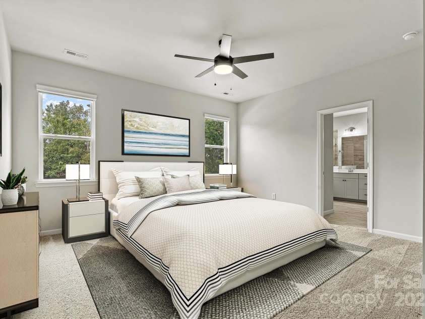 8233 Merryvale Lane, Charlotte, NC 28214.  MLS# CAR4293433, YatesRealty ID 34155. This virtually staged primary suite offers a spacious, light-filled retreat designed for ultimate relaxation—where comfort meets elegance in every corner