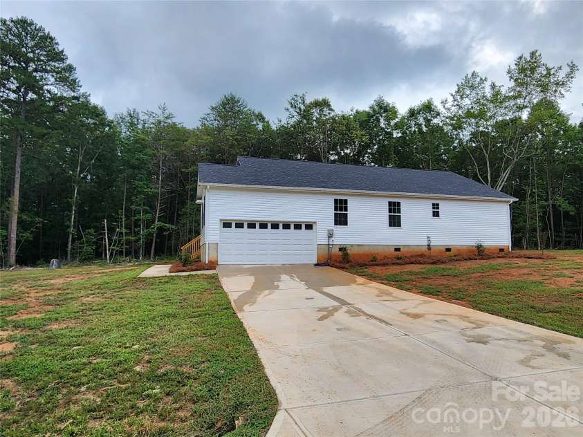 5900 Flamingo Drive, Conover, NC 28613.  MLS# CAR4415177, YatesRealty ID 34158. Right Elev w/ Side Load Garage and Decorative Landscaping