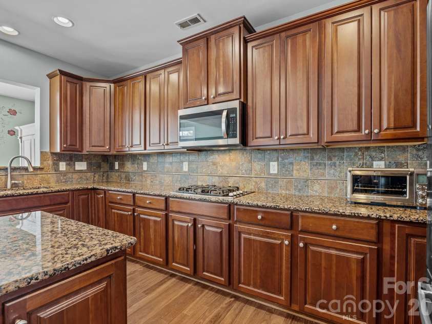 7321 Waterwheel Street, Concord, NC 28025.  MLS# CAR4342444, YatesRealty ID 34192. Kitchen, wood floors
