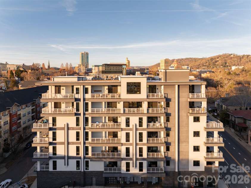 145 Biltmore Avenue, Asheville, NC 28801.  MLS# CAR4372434, YatesRealty ID 342. Penthouse on 7th floor of 145 Biltmore Avenue. Note large, stunning window overlooking South Slope in Asheville