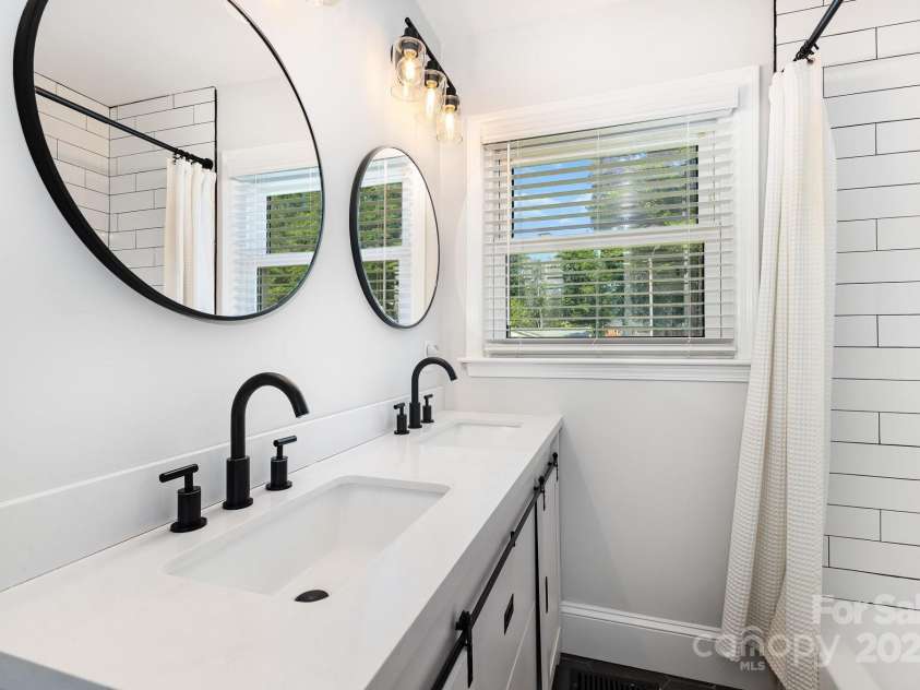 3615 Kempton Place, Charlotte, NC 28208.  MLS# CAR4262942, YatesRealty ID 34200. Beautifully renovated full bathroom with dual vanity.