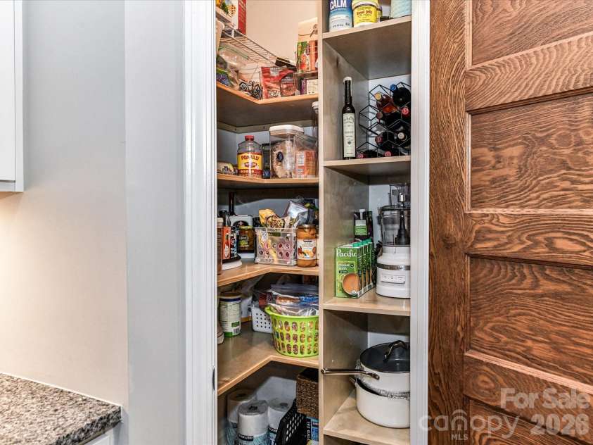 1733 Tranquility Boulevard, Lancaster, SC 29720.  MLS# CAR4393535, YatesRealty ID 34204. Customized Pantry with Solid Shelving and Antique Door