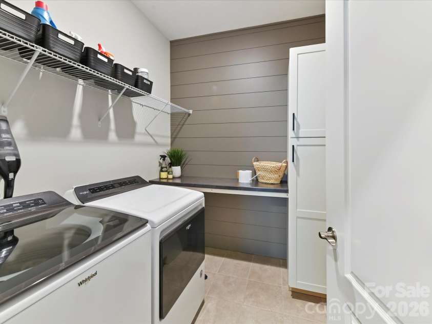 1733 Tranquility Boulevard, Lancaster, SC 29720.  MLS# CAR4393535, YatesRealty ID 34204. Laundry with Shiplap Walls, Folding Shelf and Tiled Flooring
