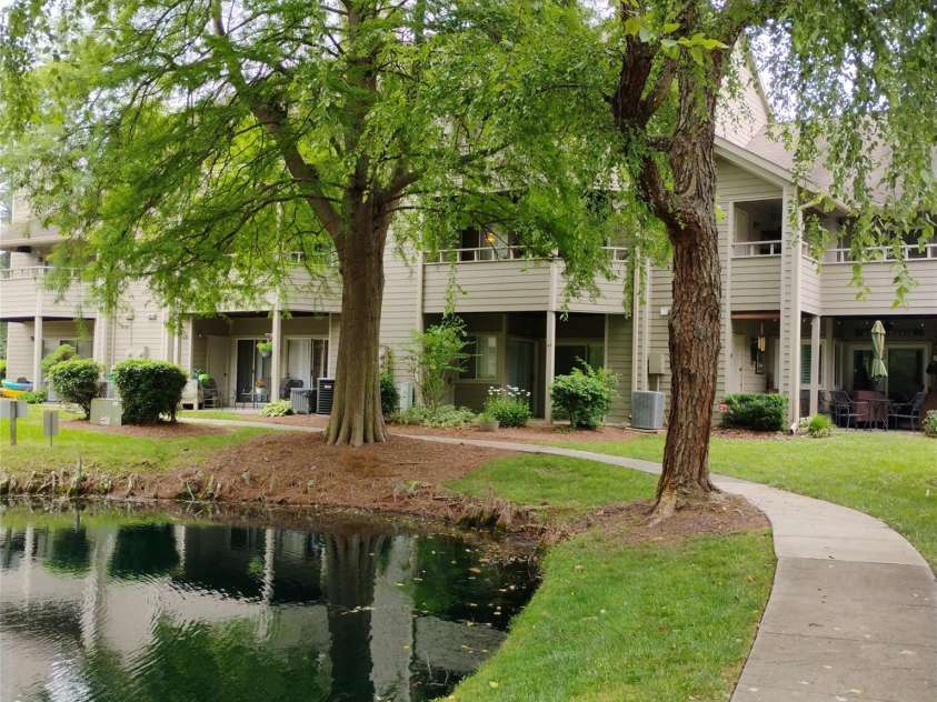 2545 Stockbridge Drive, Charlotte, NC 28210.  MLS# CAR4231252, YatesRealty ID 34208. View of building. Ground floor unit with patio overlooking pond.